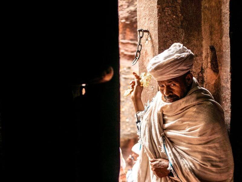 An Orthodox priest guarding the entrance of a church