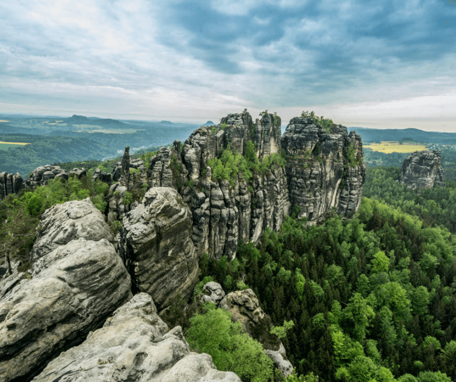 Breathtaking view from the top of the Schrammsteine, overlooking the forested valleys below