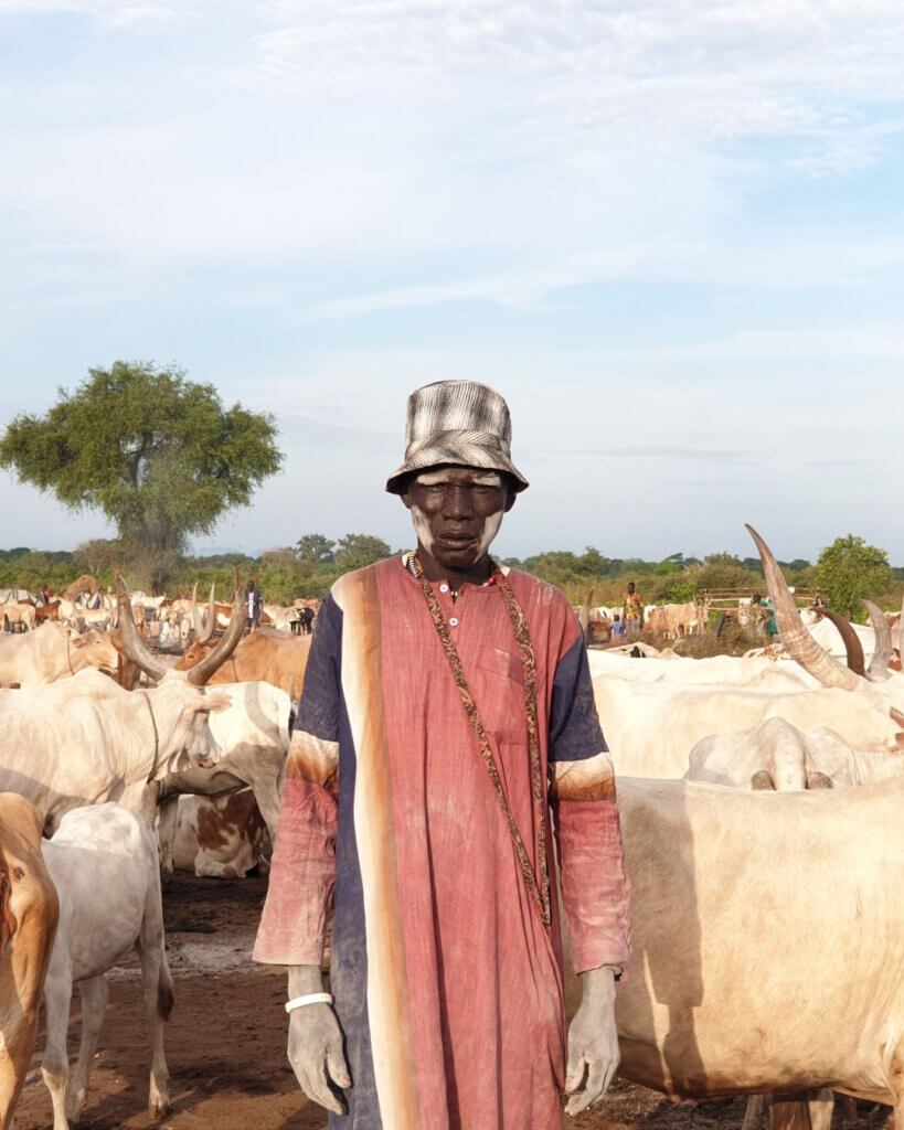 A dinka man showing us his herd of cows