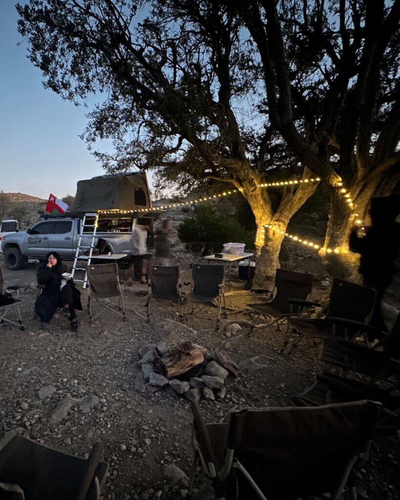 A beautiful campsite in Oman, featuring tents and camping equipment under a starry sky