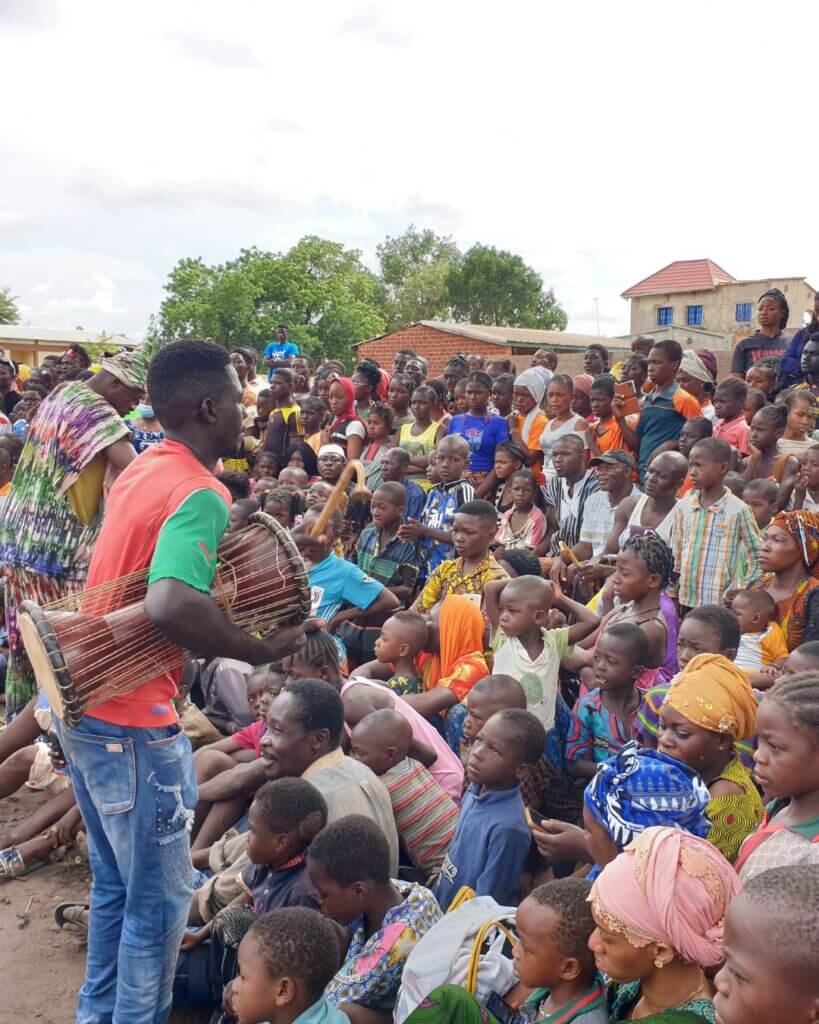 People dancing and playing drums in a funeral in Burkina Faso