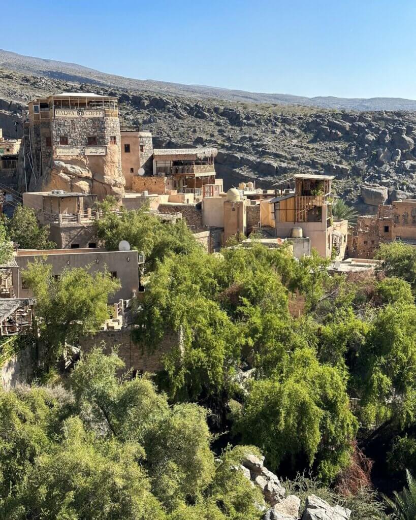 Scenic view of a traditional village nestled in the mountains of Oman, showing local culture