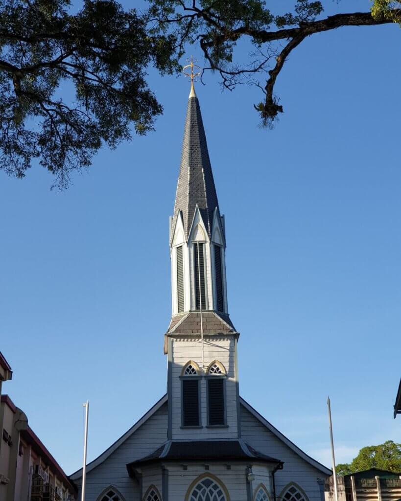 Colonial architecture in Paramaribo featuring wooden houses with detailed carvings and bright facades.