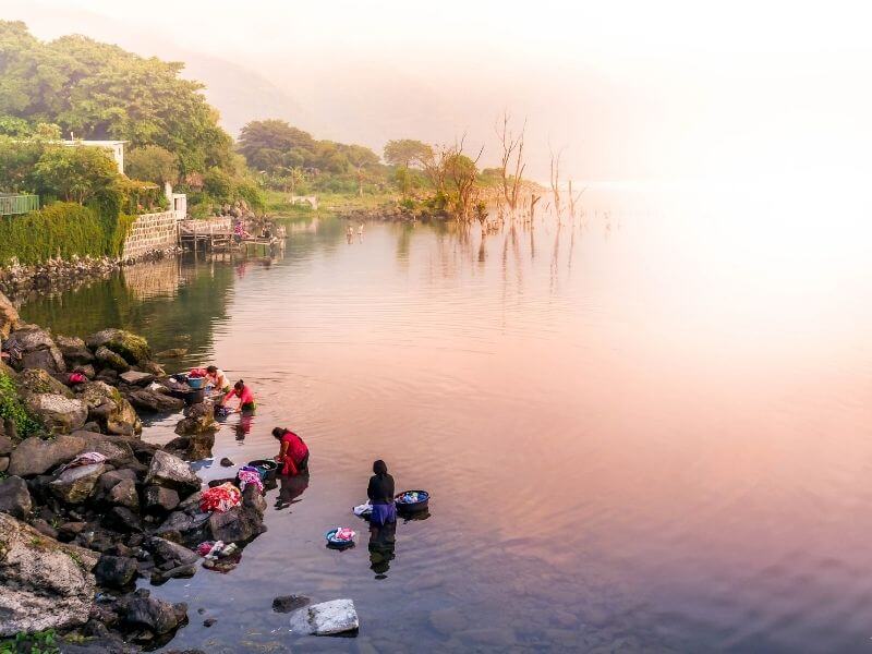 Women at sunrise washing clothes at Lake Atitlan