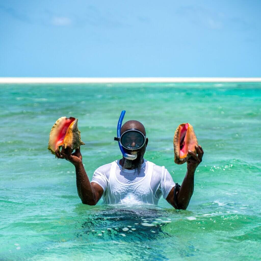 A local fisherman handpicking conch in the Bahamas