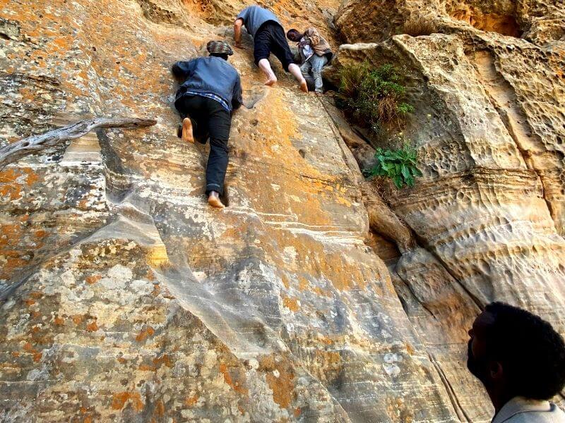 Locals and foreigners climbing up to reach Abuna Yemata Guh in Ethiopia