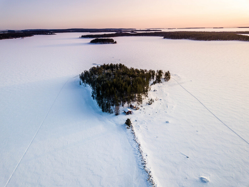 Ice cover the islands during a snowmobile tour