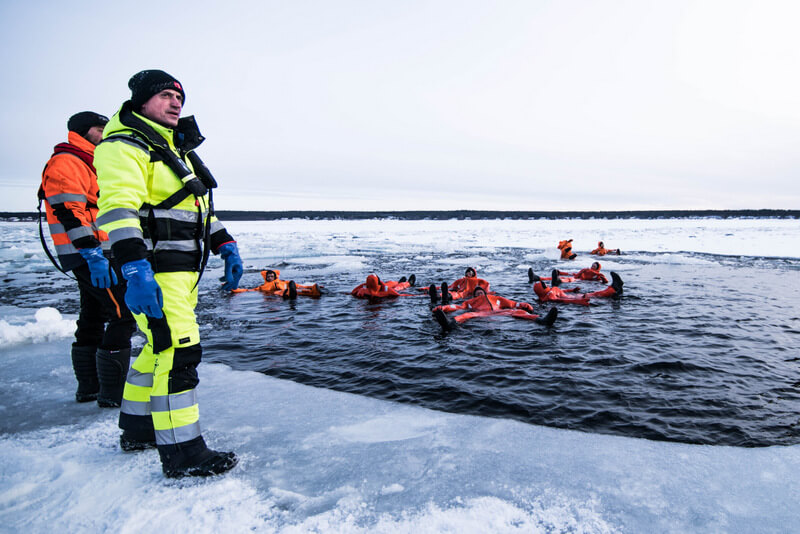 Travelers taking a swim with a dry suit in Swedish Lapland