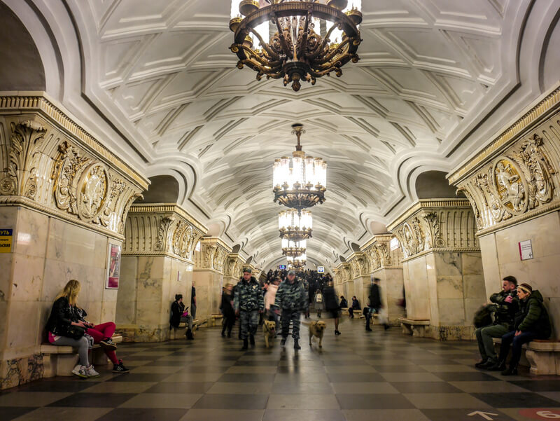 Prospekt Mira metro station in Moscow, adorned with white marble columns and floral designs on the ceiling