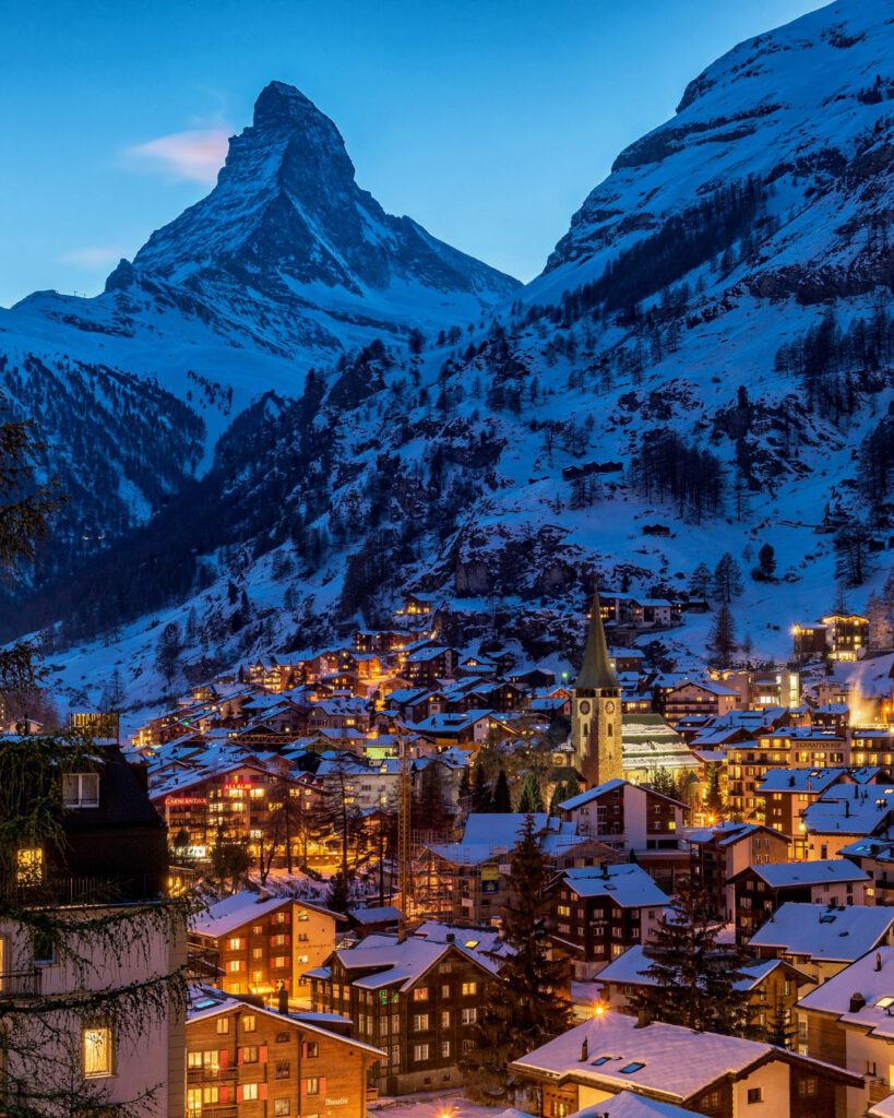 Zermatt is a skier’s paradise, sitting beneath the iconic Matterhorn peak. In December, its car-free streets are lined with chalets wrapped in twinkling lights.